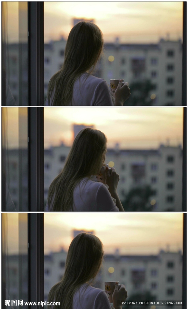 拿着杯子看窗外夕阳