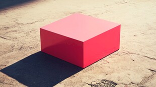 红色立方体在水泥地上投影