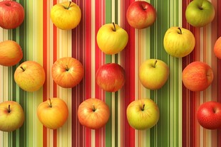 多彩苹果排列在条纹背景上
