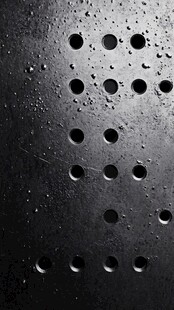 黑色金属板上的孔洞与水珠