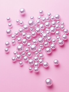 粉色背景上散落的闪亮珍珠