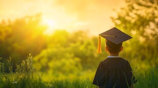 幼童着学士服眺望夕阳