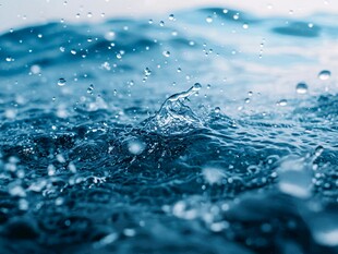 水滴落入蓝色水面瞬间