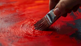 手挥画笔绘红色绚丽画面