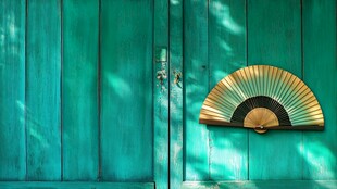 青绿色木门上的折扇装饰