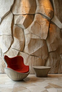 石墙前的红色创意座椅