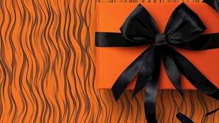 橙色礼盒配黑色蝴蝶结装饰