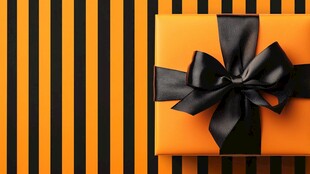 橙色礼盒配黑丝带装饰
